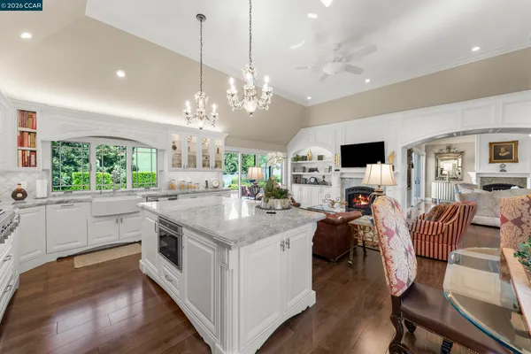 a kitchen with stainless steel appliances kitchen island a large island in the center and wooden floor