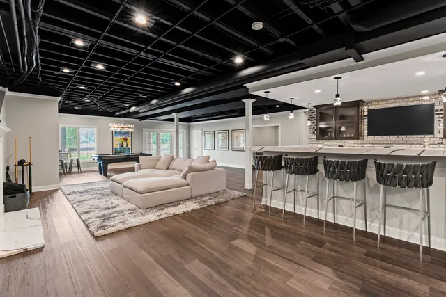 a living room with furniture and wooden floors