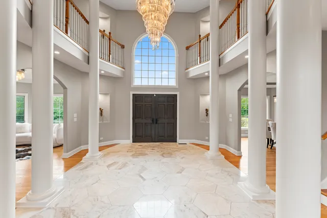 a view of a hallway with dining area and chandelier