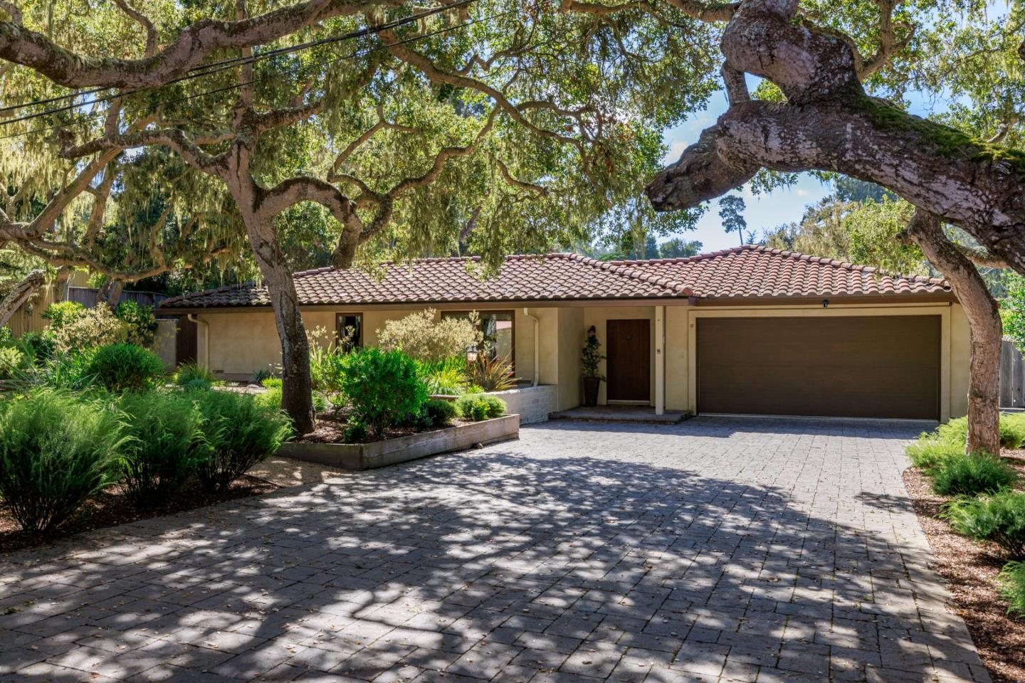 a front view of a house with a garden