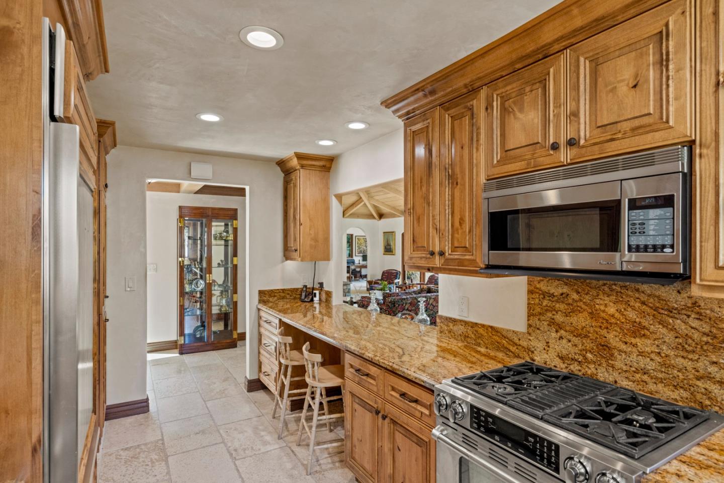 1156 Arroyo Drive Pebble Beach, CA 93953 - Photo 16 of 42 a kitchen with stainless steel appliances granite countertop a stove and a sink