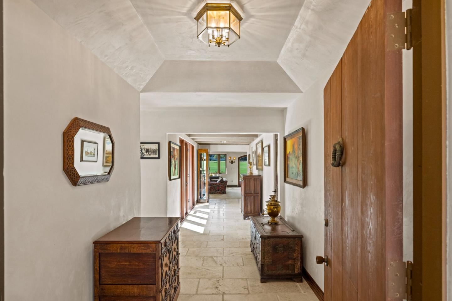 1156 Arroyo Drive Pebble Beach, CA 93953 - Photo 2 of 42 a hallway with painting on the wall and a window