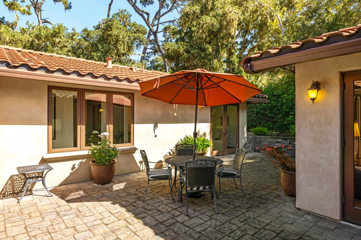 1156 Arroyo Drive Pebble Beach, CA 93953 - Photo 24 of 42 a view of a patio with table and chairs under an umbrella