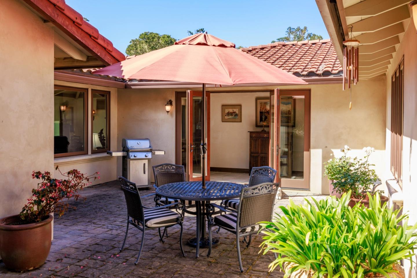 1156 Arroyo Drive Pebble Beach, CA 93953 - Photo 26 of 42 a patio with table and chairs and potted plants