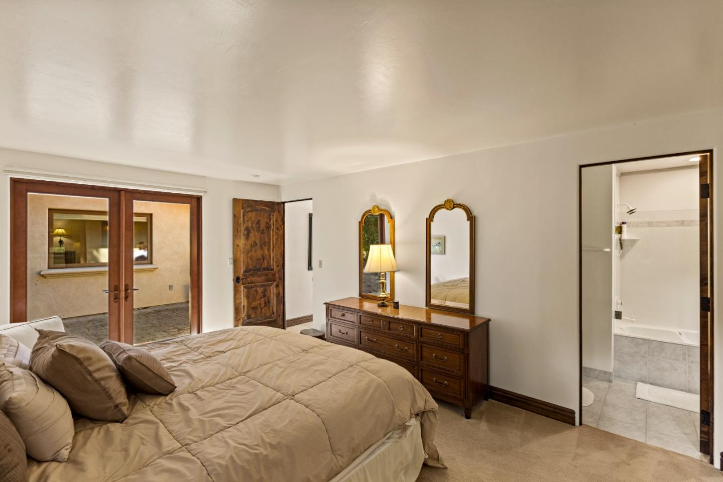 1156 Arroyo Drive Pebble Beach, CA 93953 - Photo 28 of 42 a bedroom with a bed and a large mirror with window