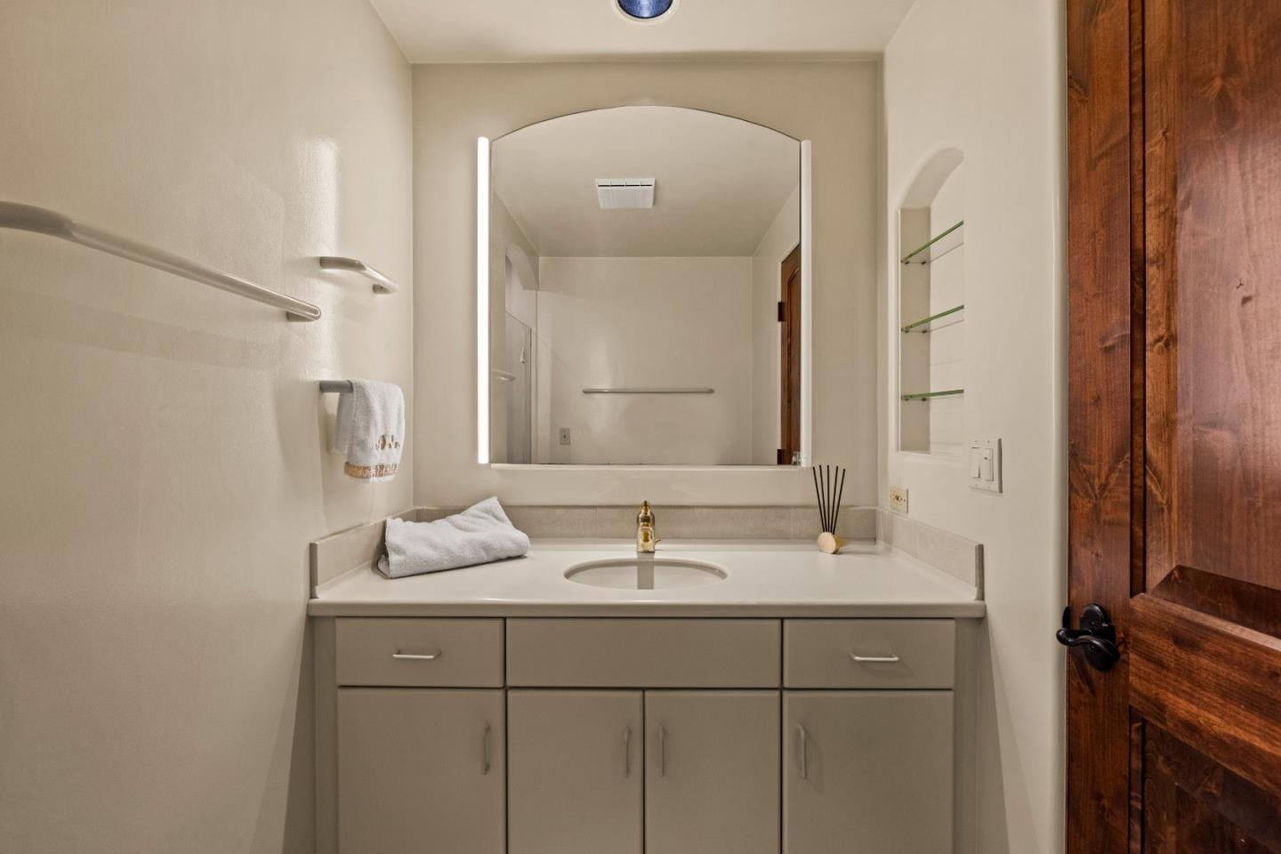 1156 Arroyo Drive Pebble Beach, CA 93953 - Photo 34 of 42 a bathroom with a sink a vanity and a mirror