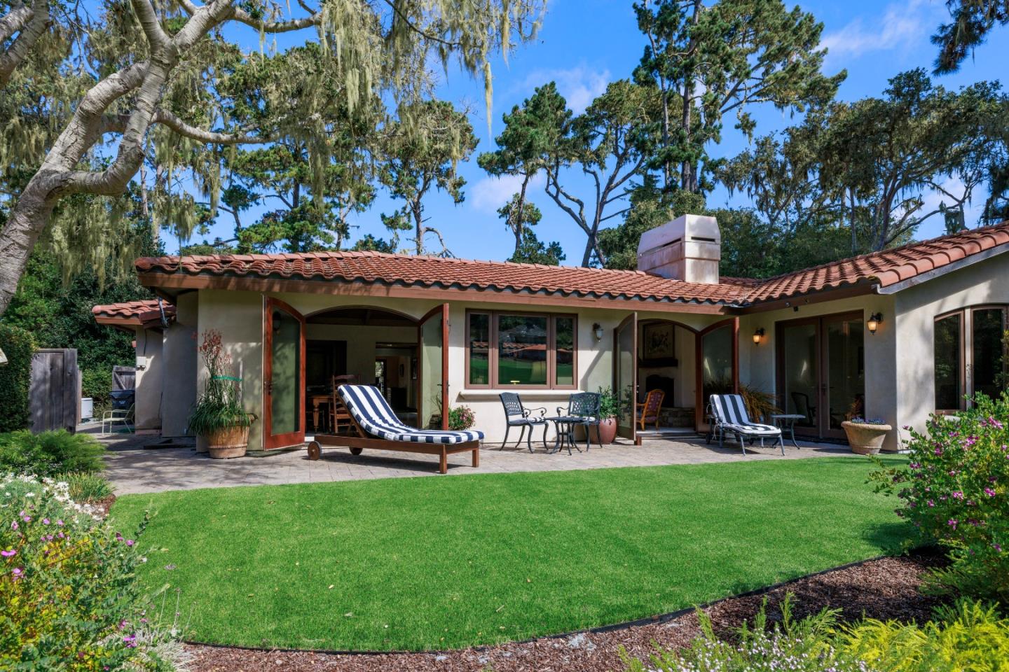 1156 Arroyo Drive Pebble Beach, CA 93953 - Photo 39 of 42 a view of a chairs and table in patio with a yard