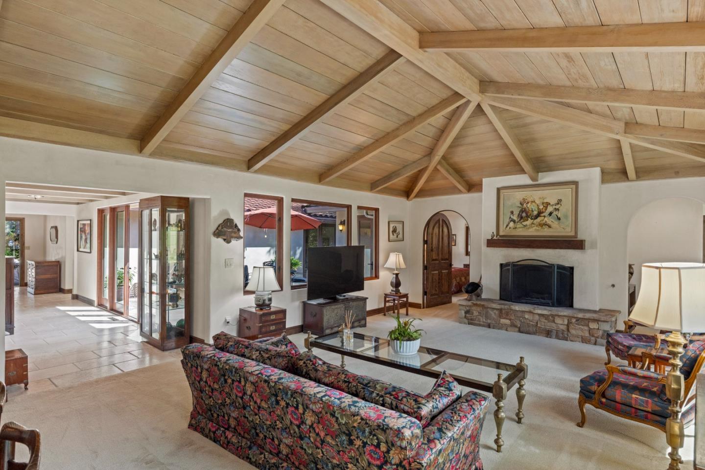 1156 Arroyo Drive Pebble Beach, CA 93953 - Photo 7 of 42 a living room with furniture a flat screen tv and a fireplace