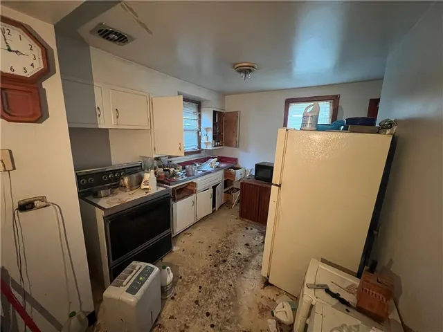 a kitchen with sink a refrigerator and a stove