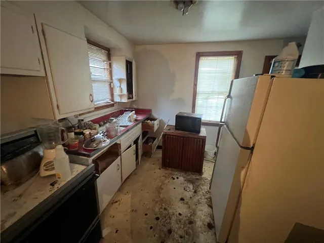 a kitchen with a sink stove and refrigerator