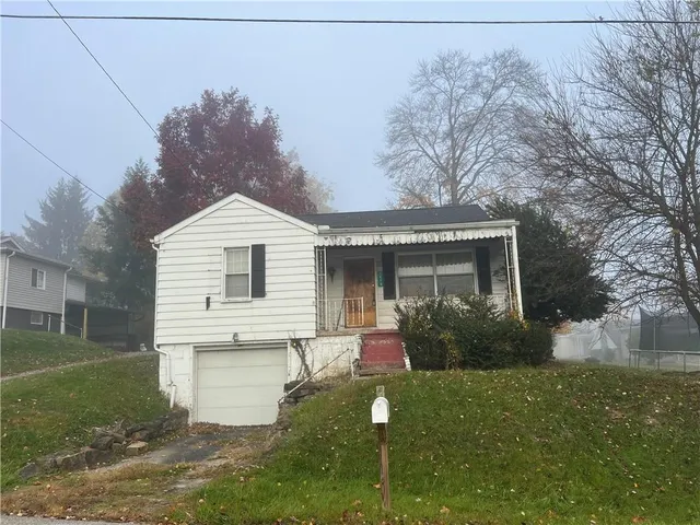 a front view of house with garden