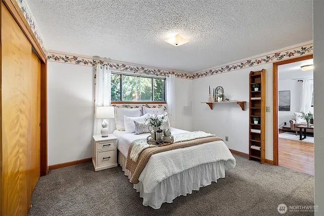a bedroom with furniture and a large window