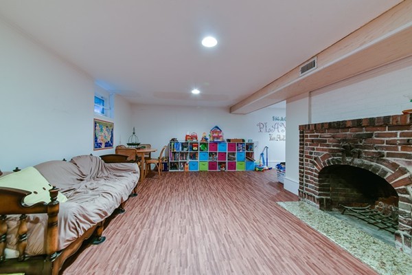 45 Earle Road Wellesley, MA 02481 - Photo 15 of 16 a living room with furniture and a fireplace