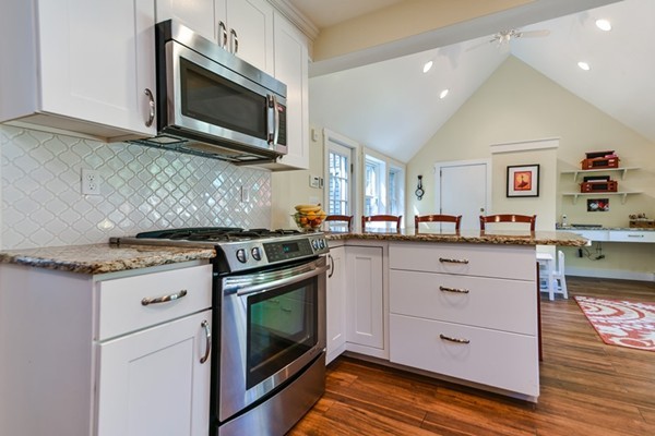45 Earle Road Wellesley, MA 02481 - Photo 3 of 16 a kitchen with stainless steel appliances granite countertop a stove microwave and cabinets
