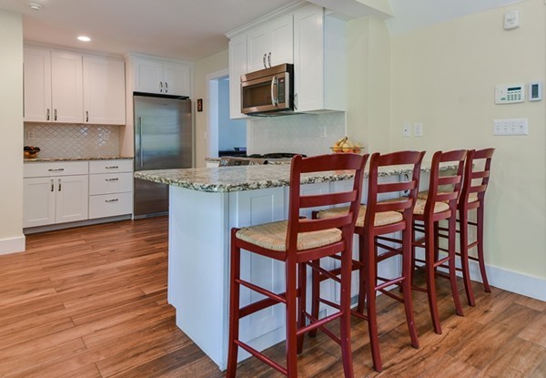 45 Earle Road Wellesley, MA 02481 - Photo 4 of 16 a kitchen with stainless steel appliances granite countertop a kitchen island a stove a cabinets and a chairs