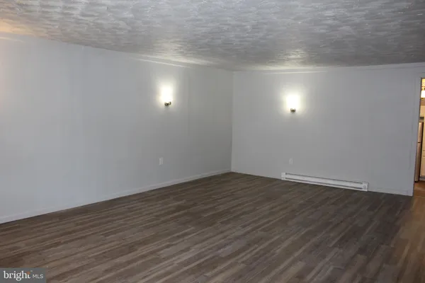 a view of an empty room and wooden floor
