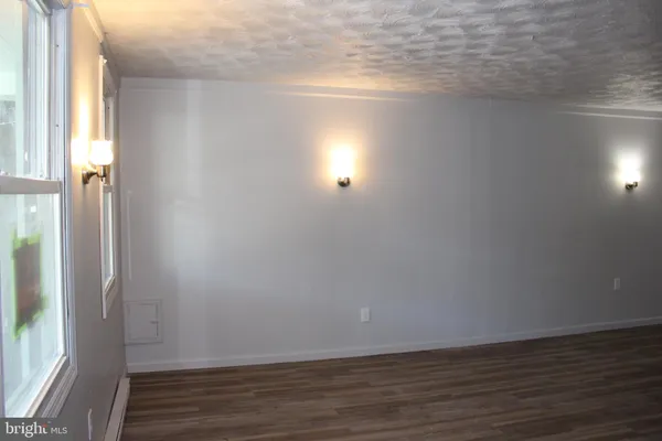 a view of an empty room and wooden floor