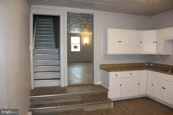 a kitchen with cabinets and window
