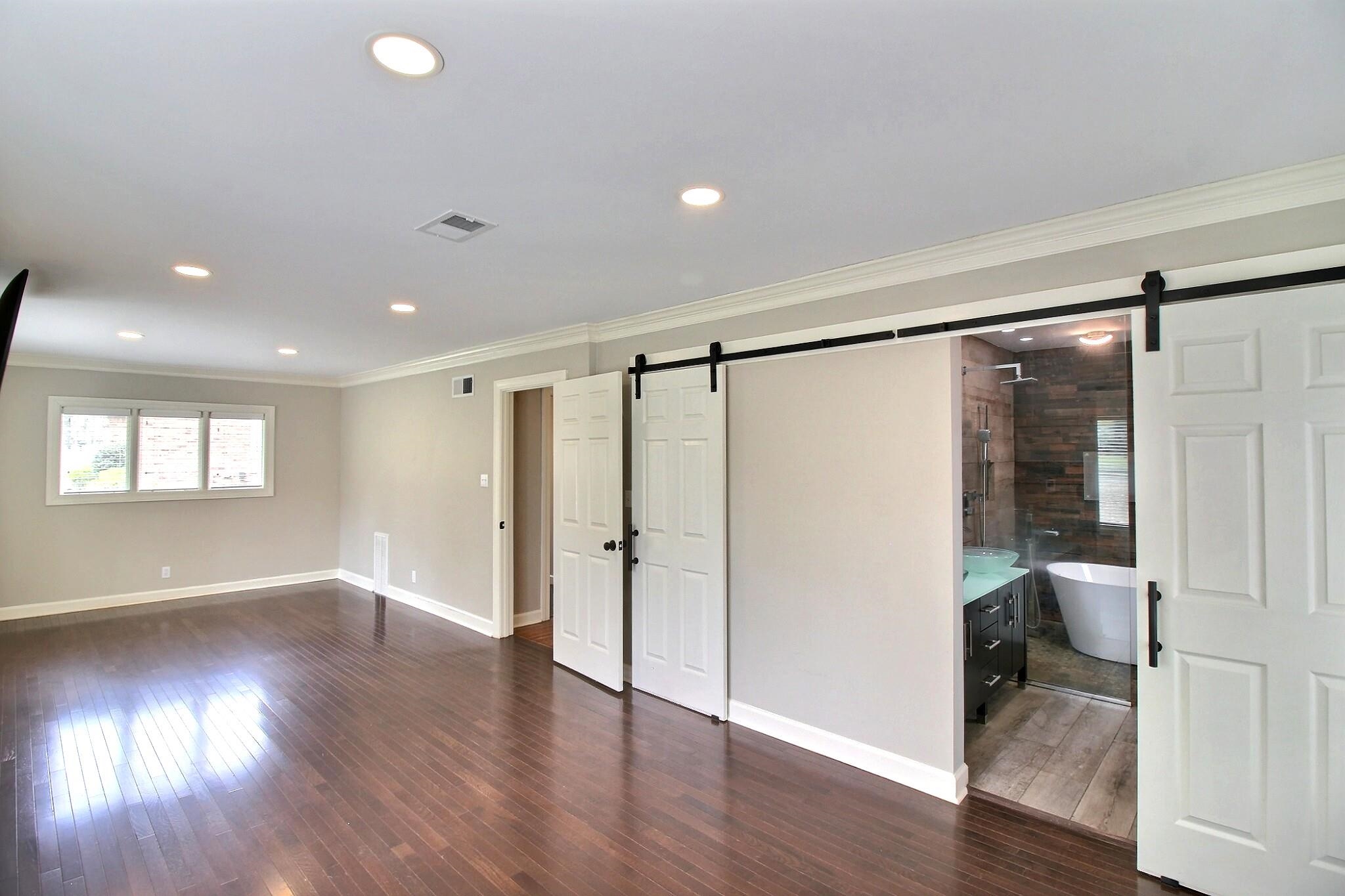 7572 Willey Road Germantown, TN 38138 - Photo 14 of 30 a view of a big room with wooden floor and windows
