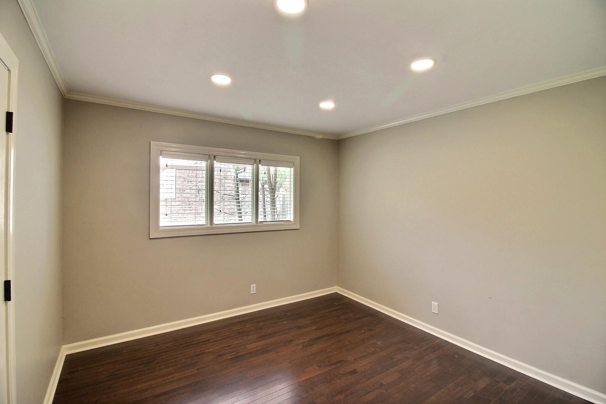 7572 Willey Road Germantown, TN 38138 - Photo 17 of 30 a view of an empty room with wooden floor and a window