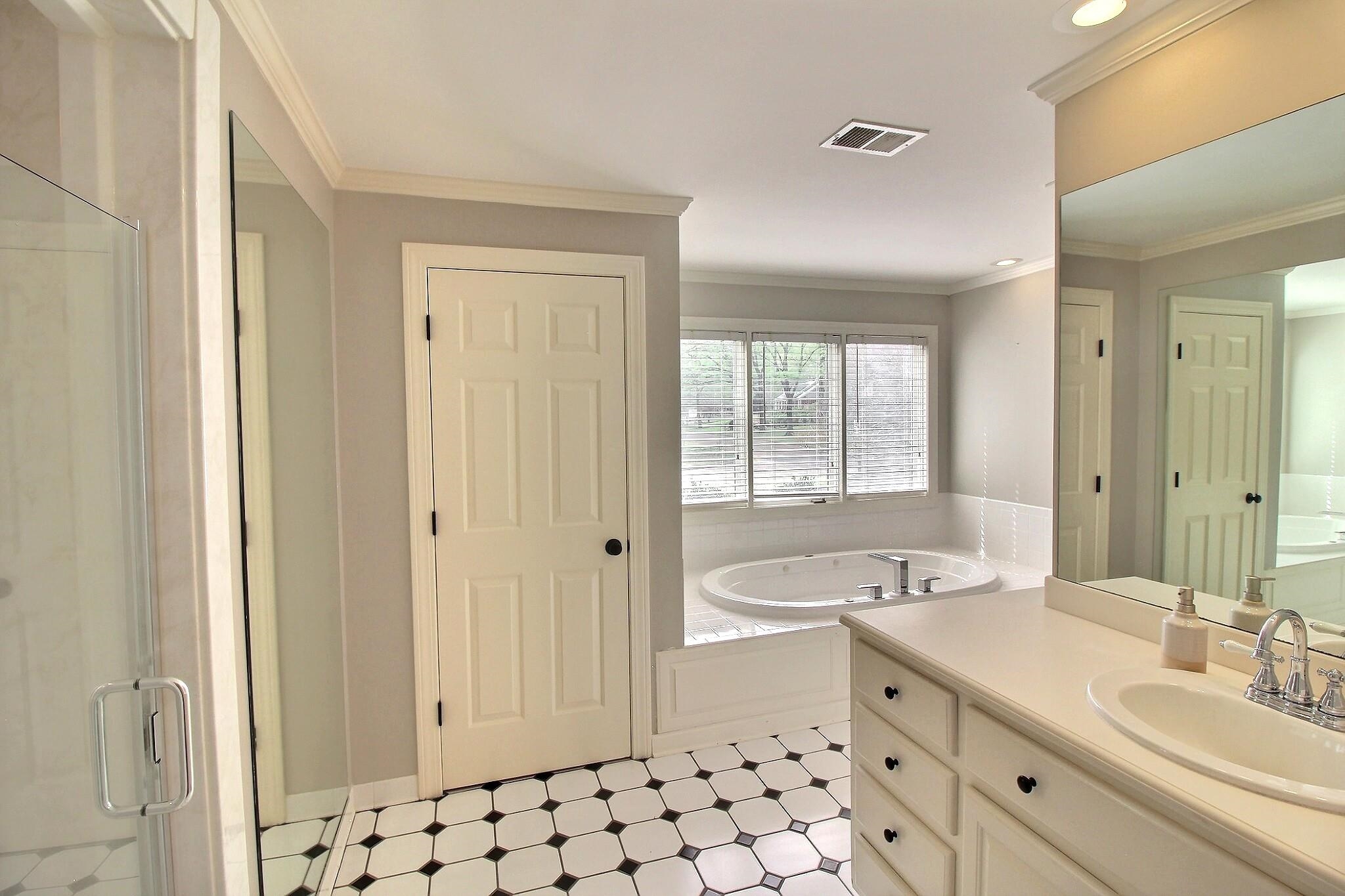 7572 Willey Road Germantown, TN 38138 - Photo 25 of 30 a bathroom with a double vanity sink mirror and bathtub