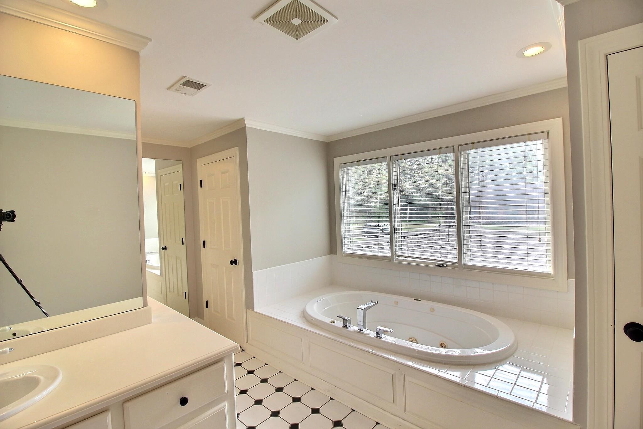 7572 Willey Road Germantown, TN 38138 - Photo 26 of 30 a bathroom with a tub a sink and a window