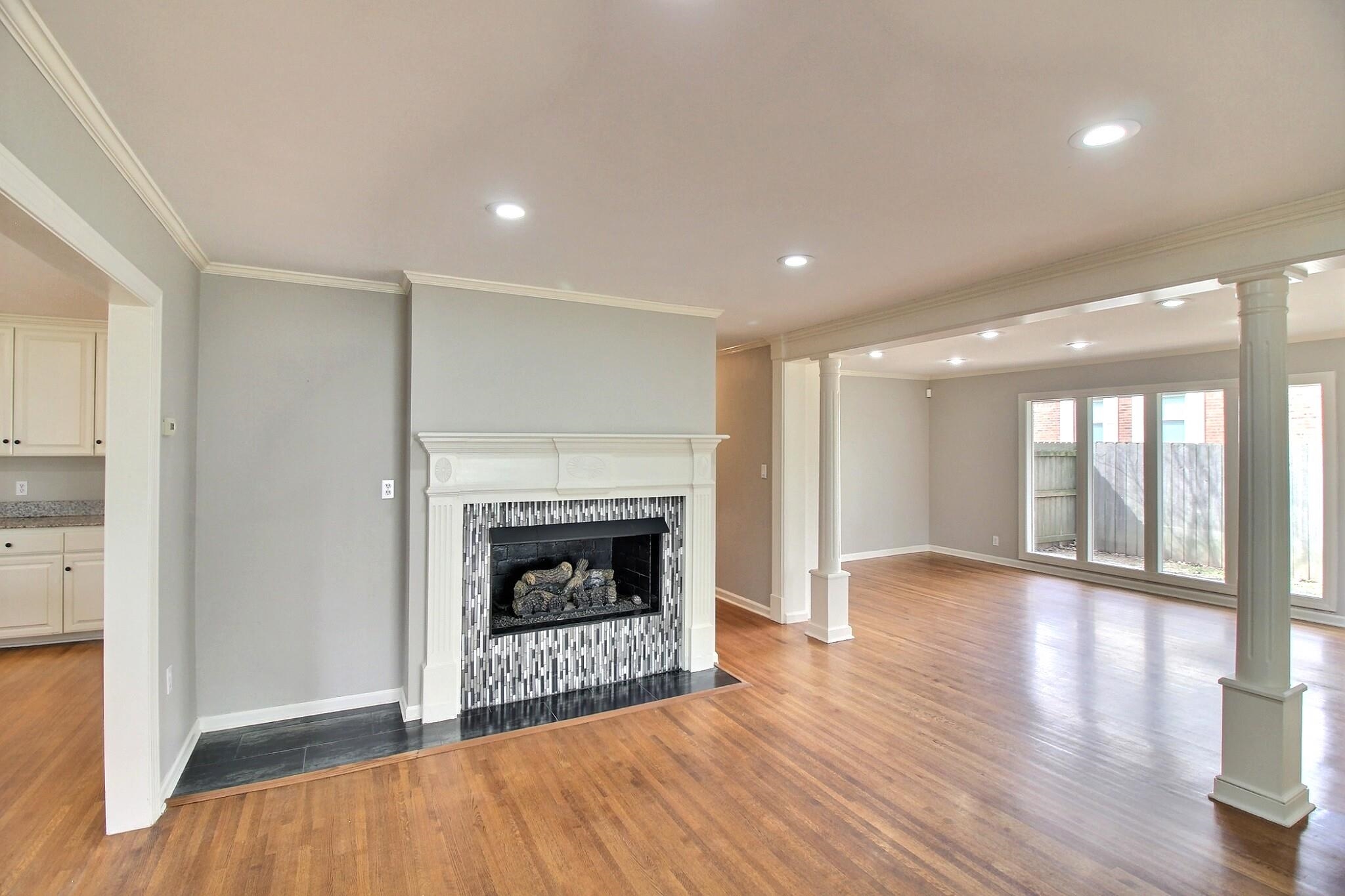 7572 Willey Road Germantown, TN 38138 - Photo 5 of 30 a view of an empty room with wooden floor fireplace and a window
