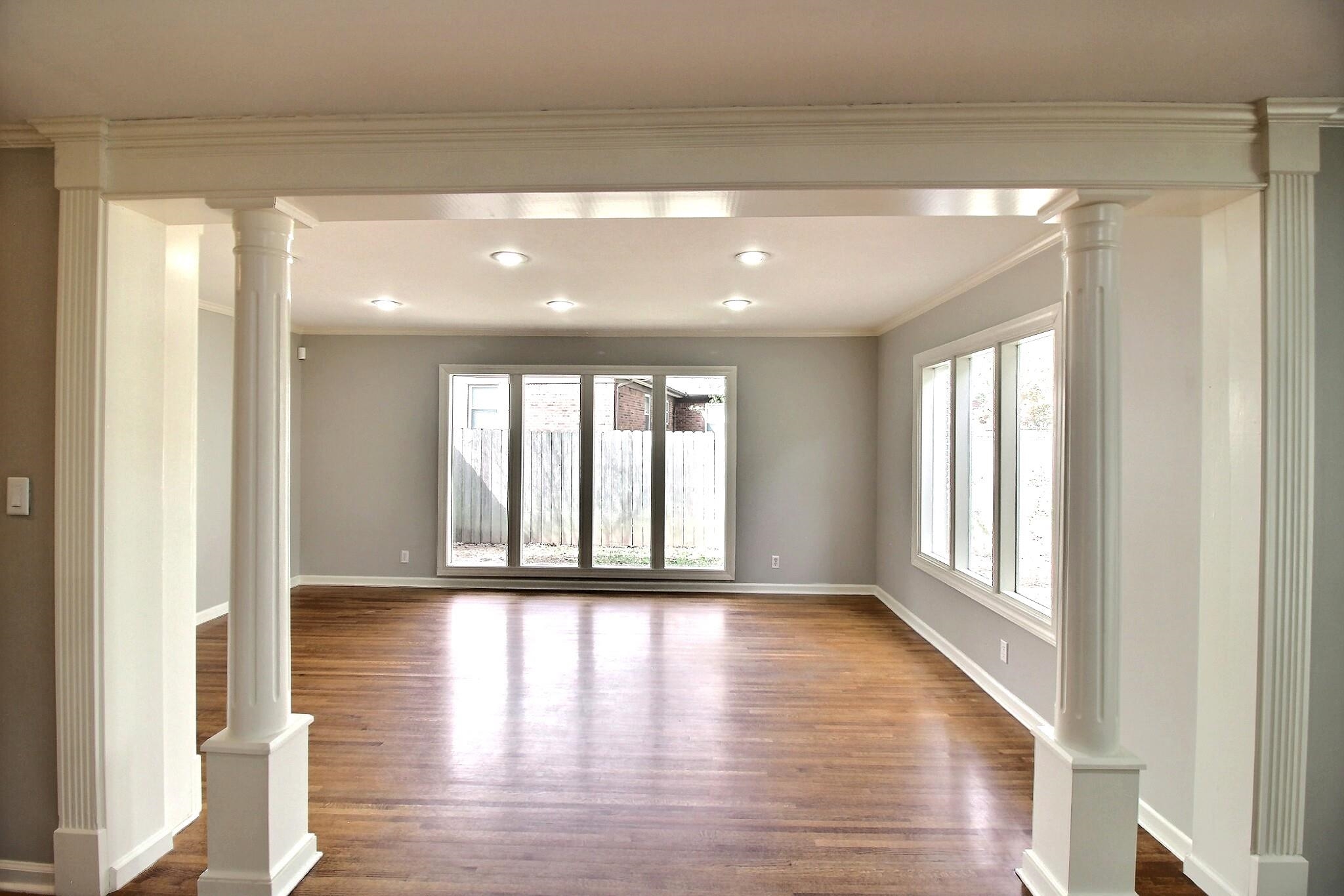 7572 Willey Road Germantown, TN 38138 - Photo 7 of 30 a view of an empty room with wooden floor and a window