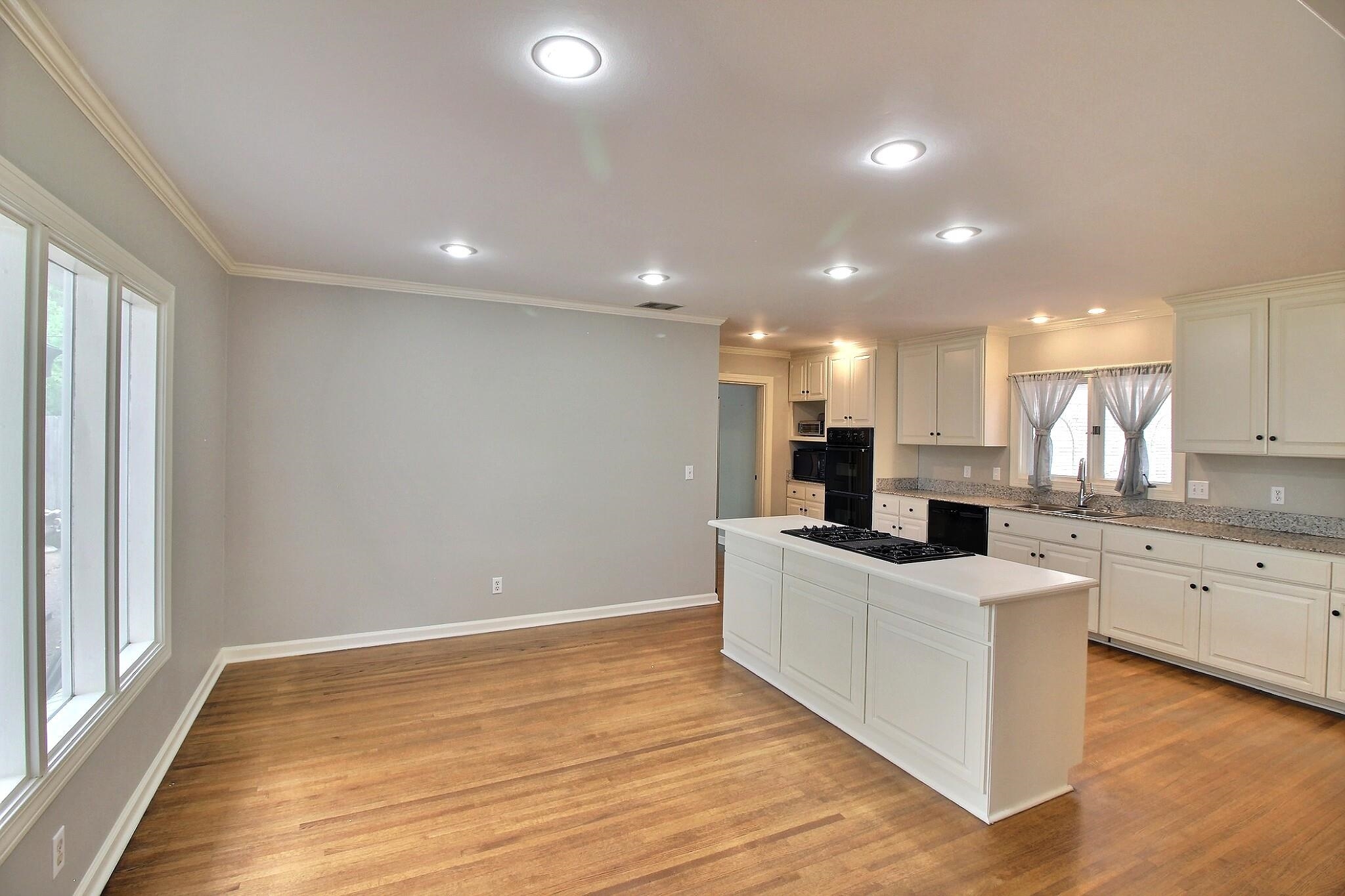 7572 Willey Road Germantown, TN 38138 - Photo 9 of 30 a large kitchen with stainless steel appliances kitchen island a large counter top and a wooden floors