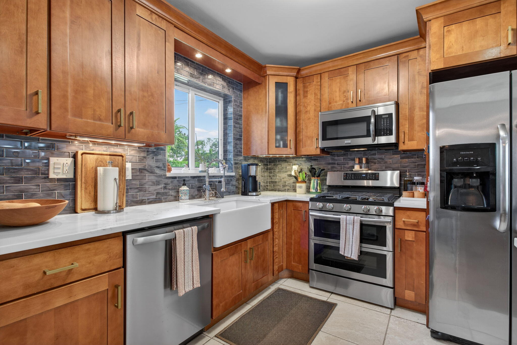 425 Southwest 10th Street Pompano Beach, FL 33060 - Photo 23 of 47 a kitchen with stainless steel appliances granite countertop a stove a sink dishwasher a microwave oven with granite countertops and cabinets
