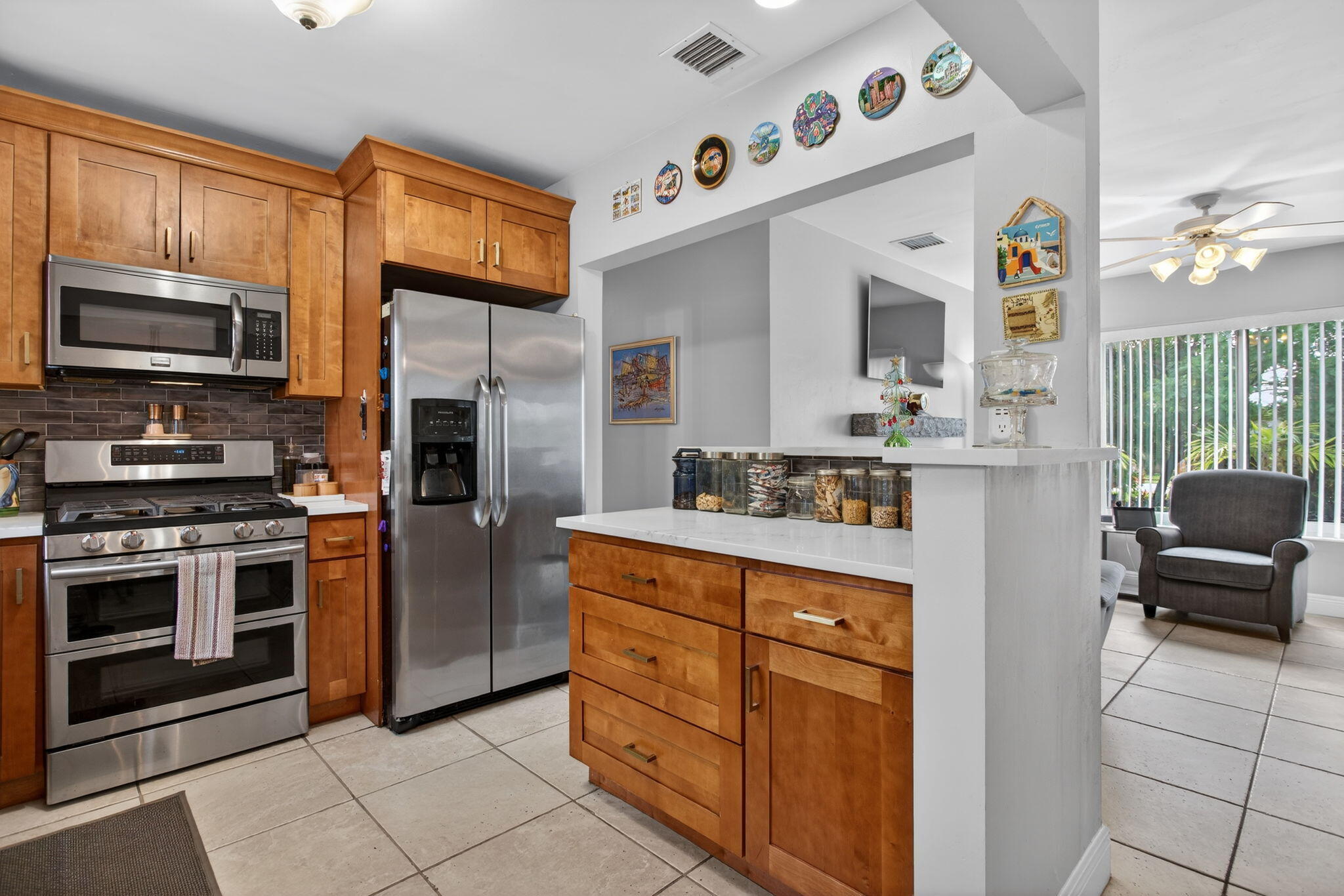 425 Southwest 10th Street Pompano Beach, FL 33060 - Photo 24 of 47 a kitchen with stainless steel appliances granite countertop a refrigerator and a stove top oven