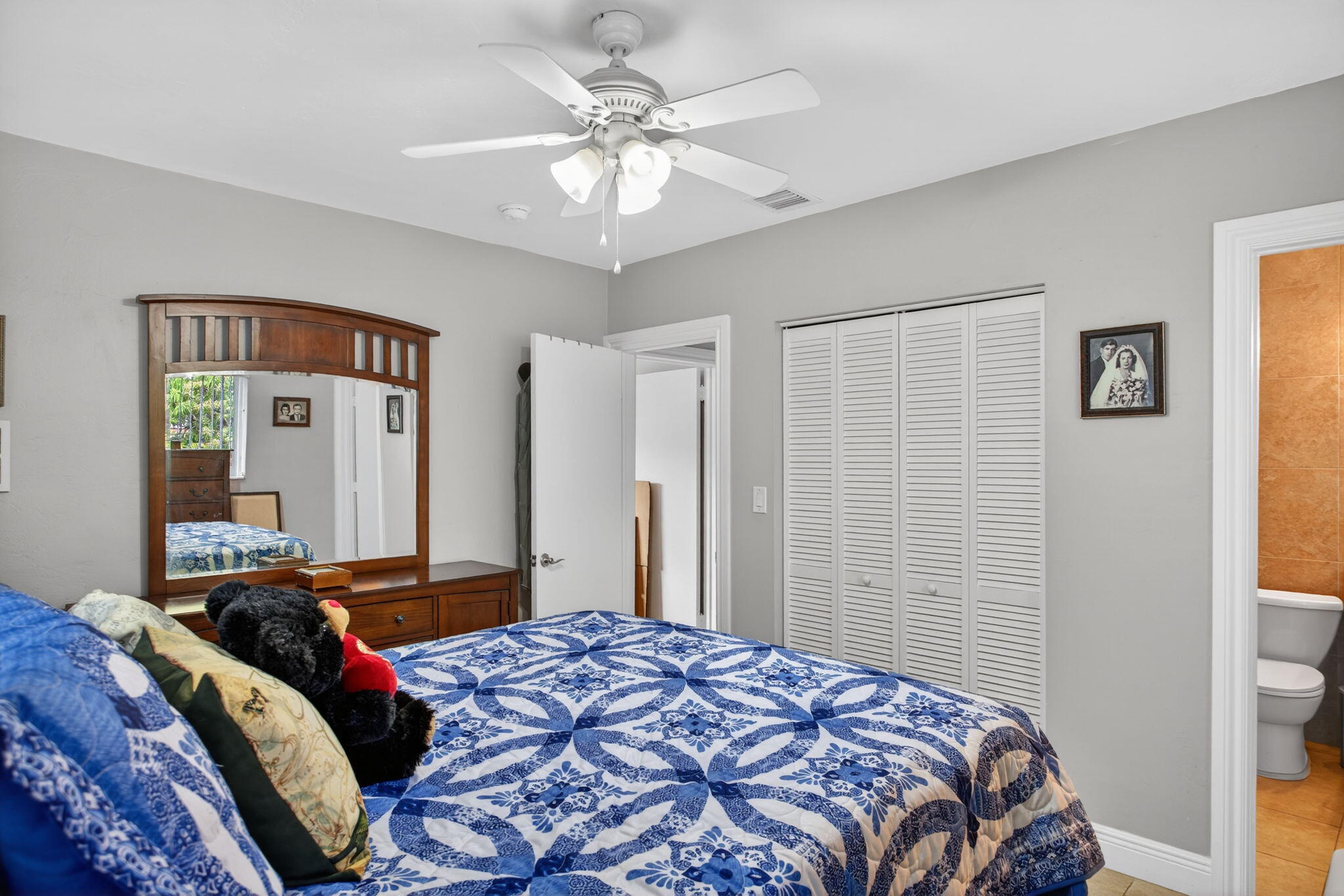425 Southwest 10th Street Pompano Beach, FL 33060 - Photo 33 of 47 a bedroom with a large bed and a chandelier