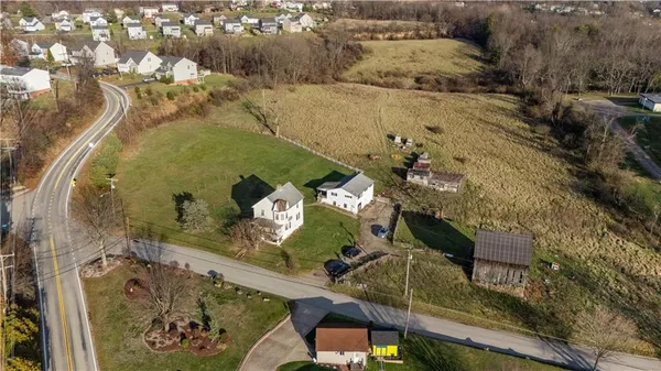 an aerial view of a house with a yard