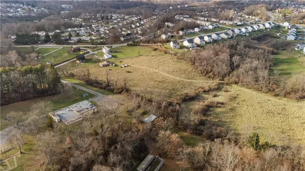 an aerial view of a residential houses with outdoor space