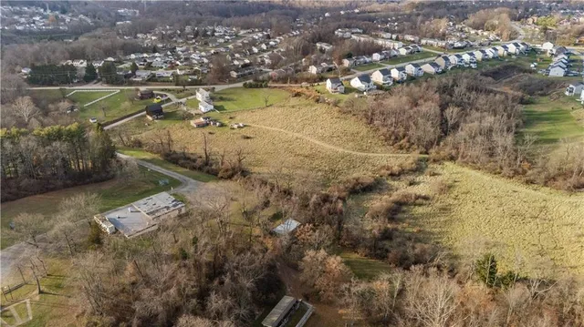 an aerial view of a residential houses with outdoor space