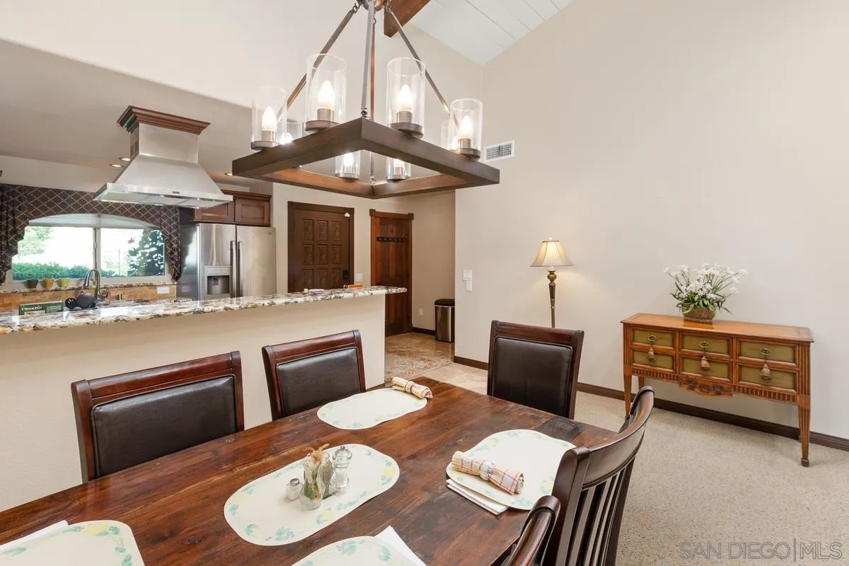 17442 Port Marnock Drive Poway, CA 92064 - Photo 11 of 28 a dining room with furniture and a chandelier