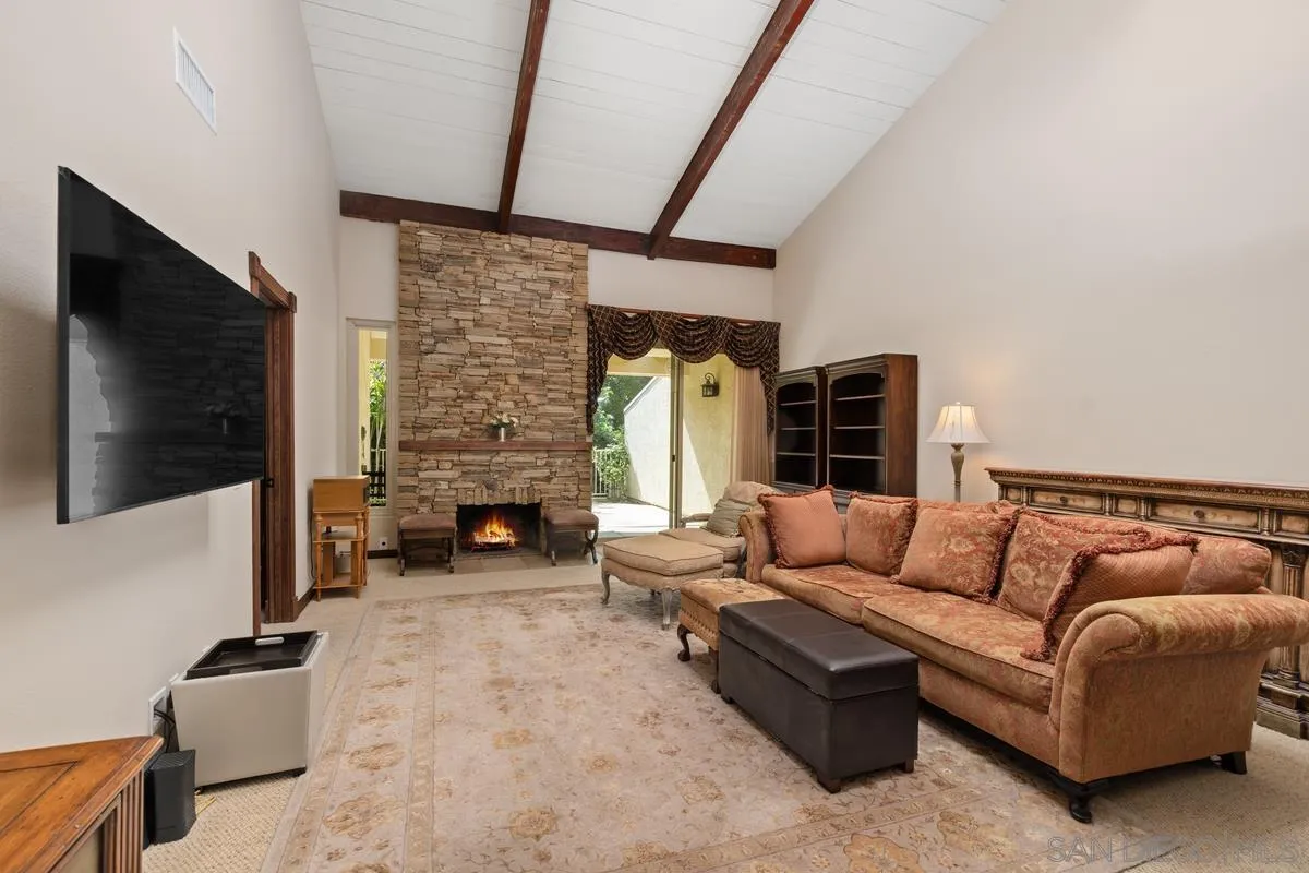 17442 Port Marnock Drive Poway, CA 92064 - Photo 15 of 28 a living room with furniture a flat screen tv and a fireplace