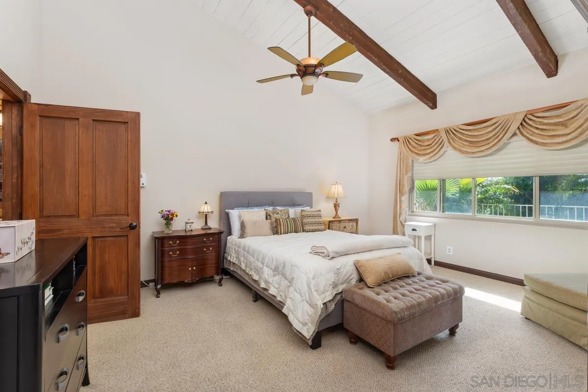 17442 Port Marnock Drive Poway, CA 92064 - Photo 17 of 28 a spacious bedroom with a bed dresser and a window