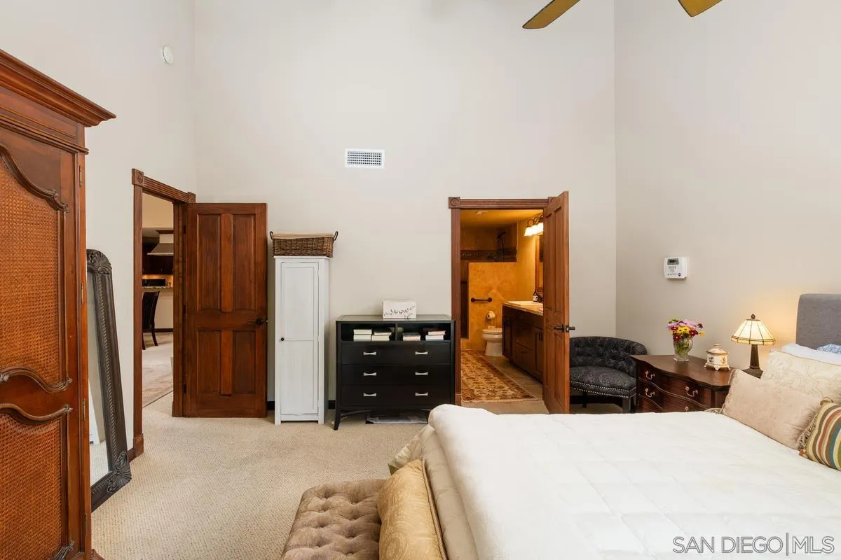 17442 Port Marnock Drive Poway, CA 92064 - Photo 18 of 28 a bedroom with a bed and dresser with mirror