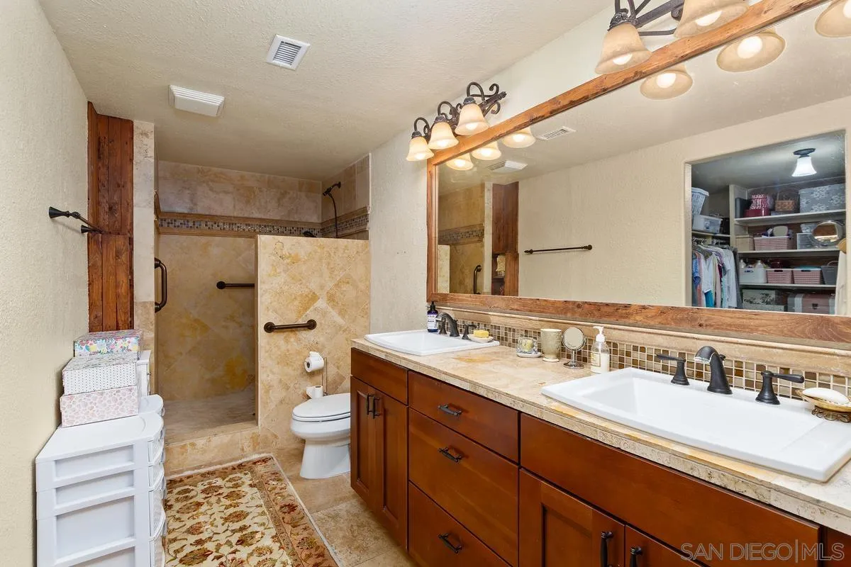17442 Port Marnock Drive Poway, CA 92064 - Photo 19 of 28 a spacious bathroom with a double vanity sink toilet mirror and shower