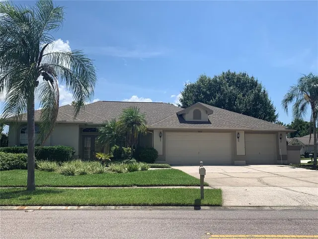 a front view of a house with a garden and plants