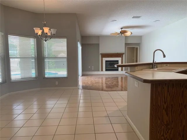 a kitchen with kitchen island granite countertop a stove a sink and a refrigerator