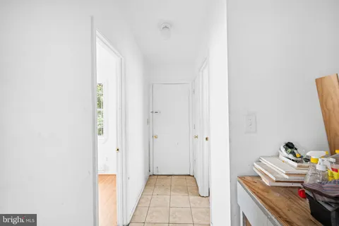 a hallway with a bed and a window