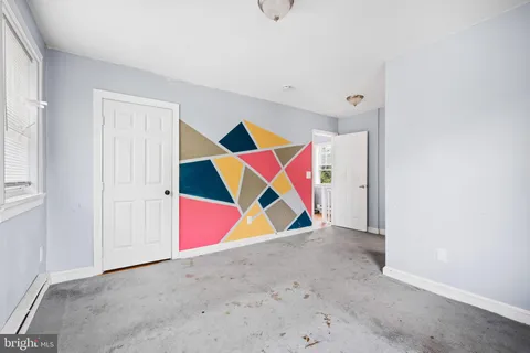 an room with white cabinets and a ceiling fan
