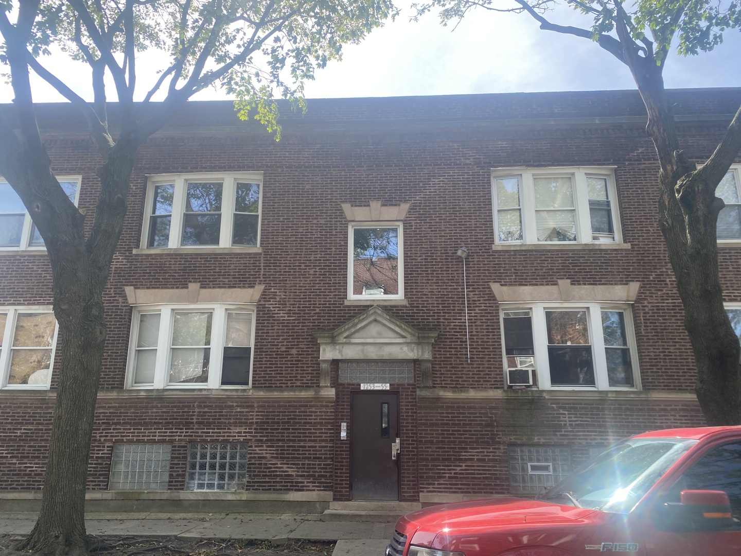 1253 West 80th Street, Unit 2E Chicago, IL 60620 - Photo 1 of 10 a front view of a house with yard