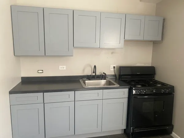 a white bath tub sitting next to a white toilet and a window