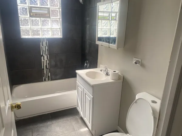 a view of a room with wooden floor and a window