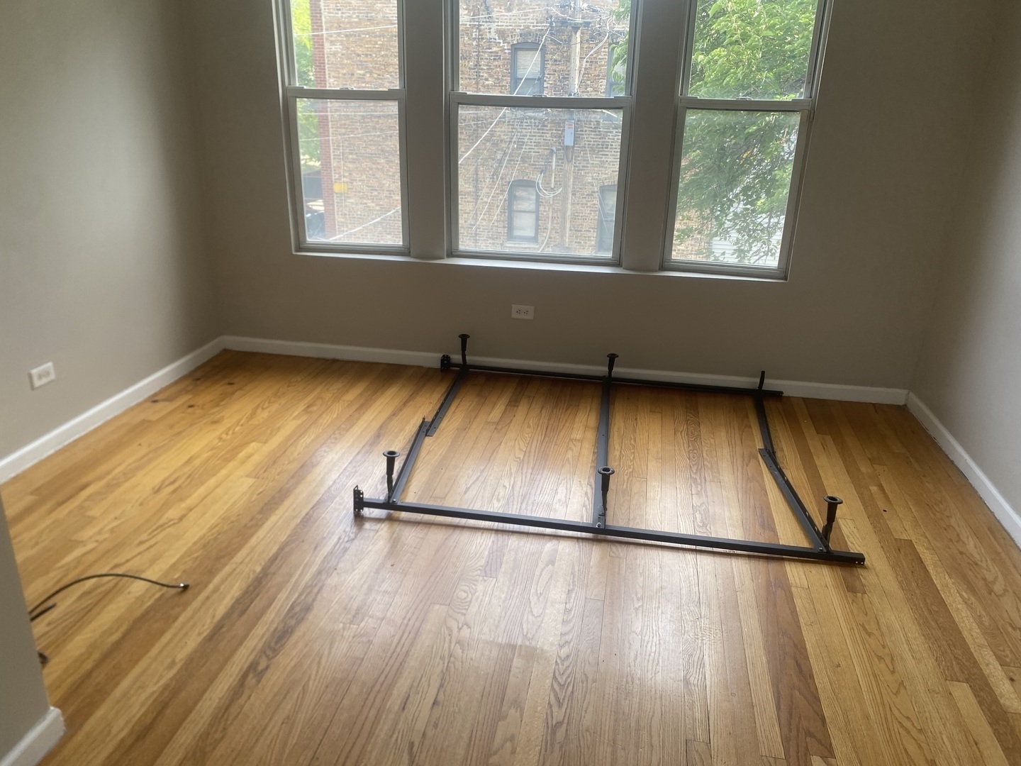 1253 West 80th Street, Unit 2E Chicago, IL 60620 - Photo 9 of 10 a view of a room with wooden floor and a window