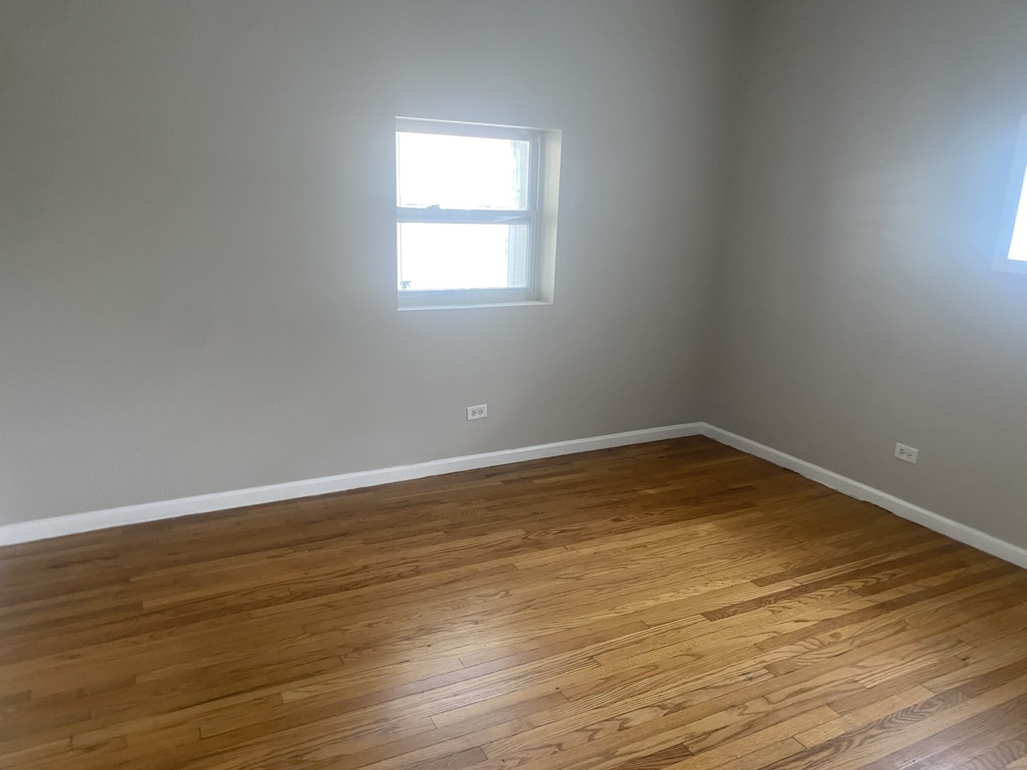 1253 West 80th Street, Unit 2E Chicago, IL 60620 - Photo 10 of 10 a view of a room with wooden floor and a window