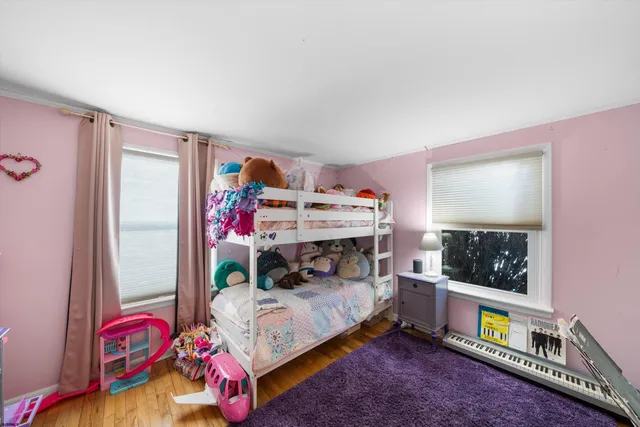 a bedroom with furniture and a flat screen tv